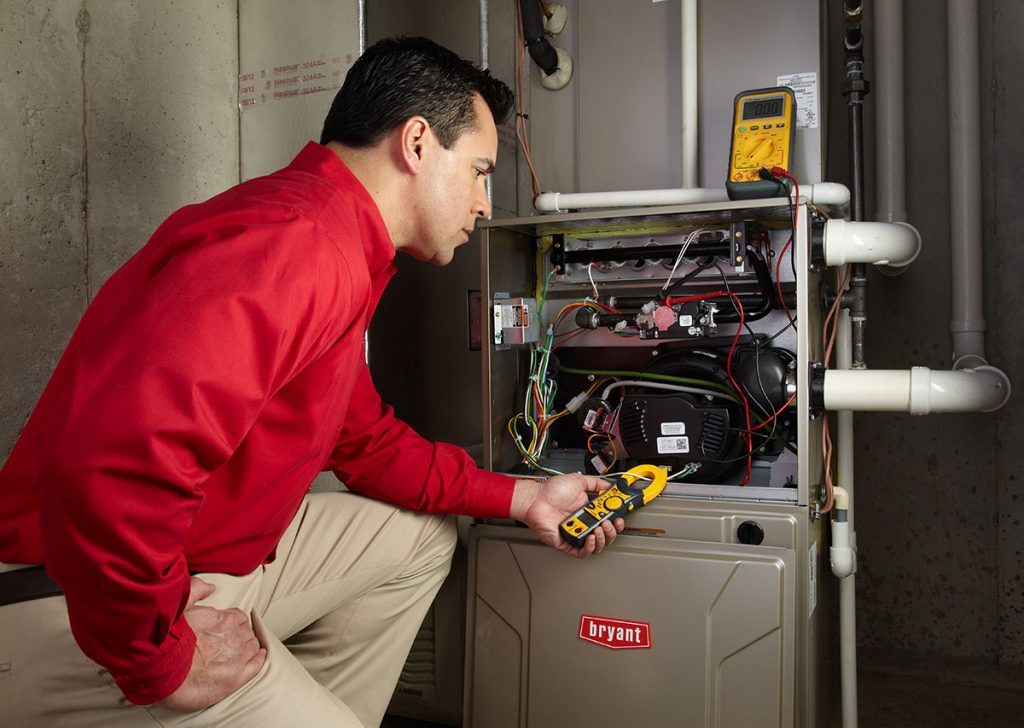 HVAC technician repairing an indoor furnace in Buckeye