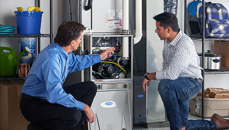 HVAC technician evaluating a furnace for repair or replacement in Buckeye