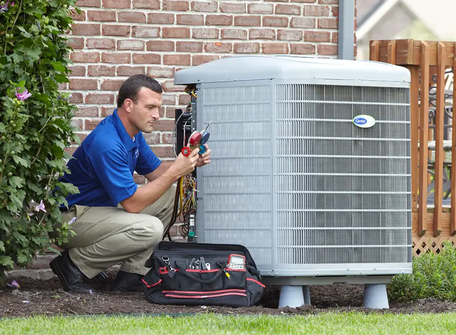 HVAC technician inspecting an outdoor air conditioning unit in Buckeye
