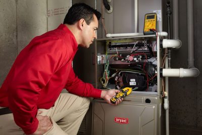 furnace repair Heating and air conditioning technician servicing an indoor furnace in Buckeye, AZ
